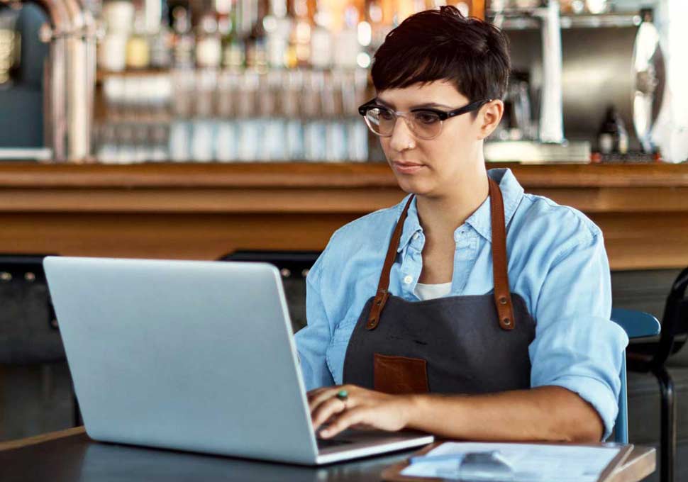 Small busines owner using laptop.